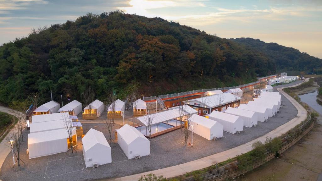 Campers setting up tents near a forested area outside Seoul