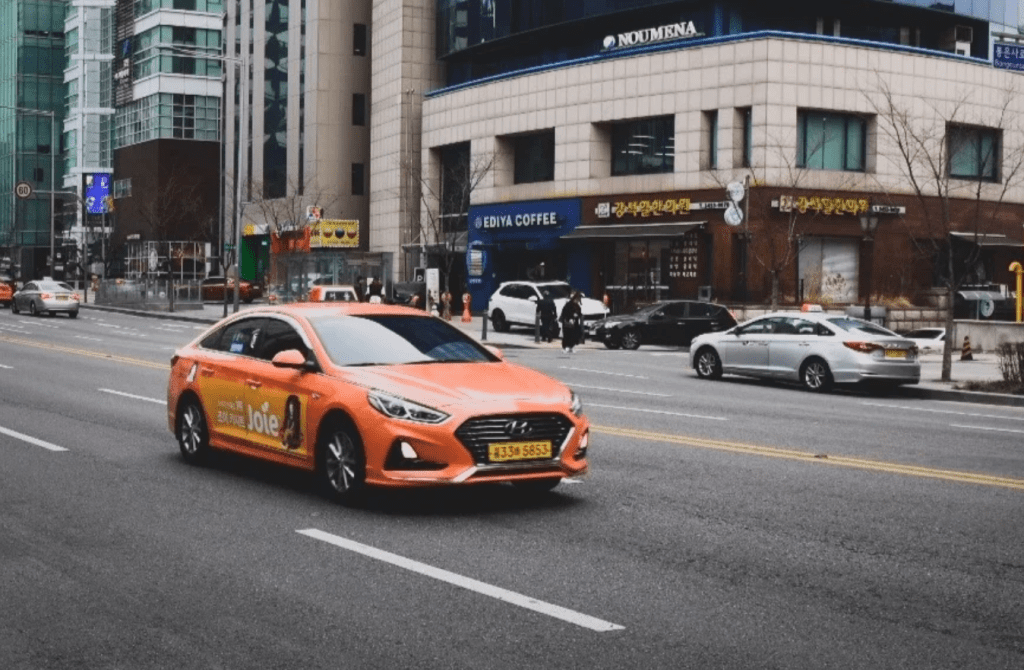 Seoul taxi driving through city streets at night