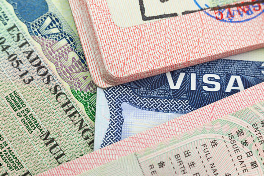 Travel visas and passports arranged together for trip preparation