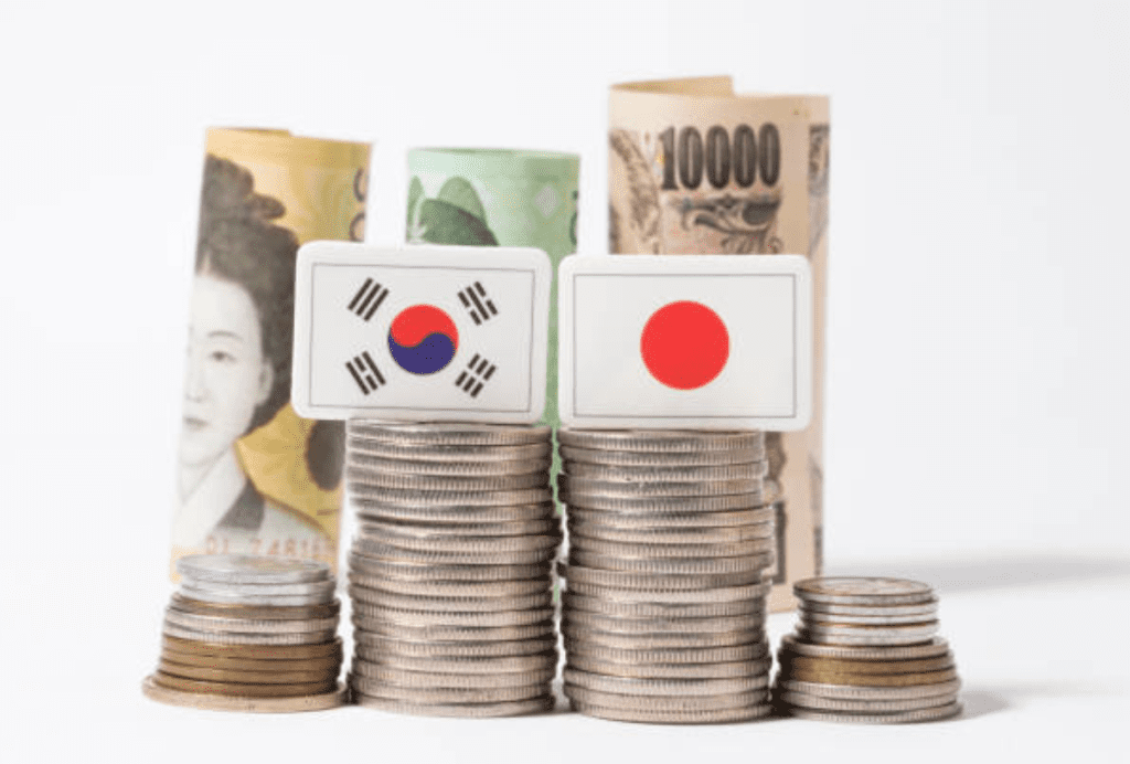 South Korean won banknotes and coins spread out on table